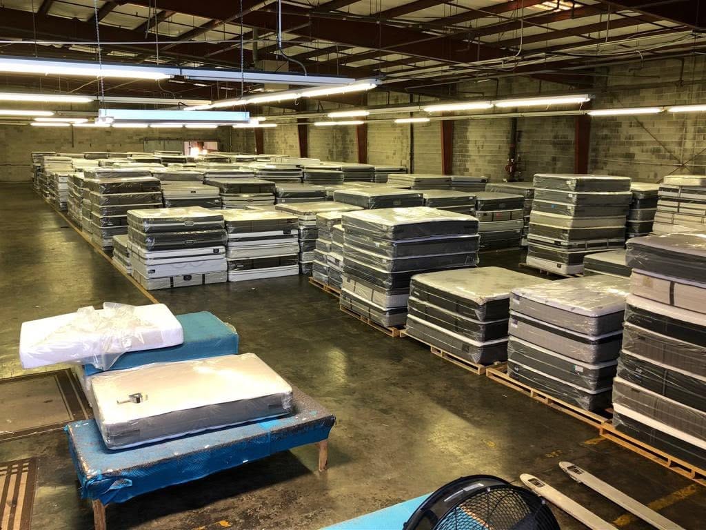 Rows of mattresses in stock at the World Furniture warehouse